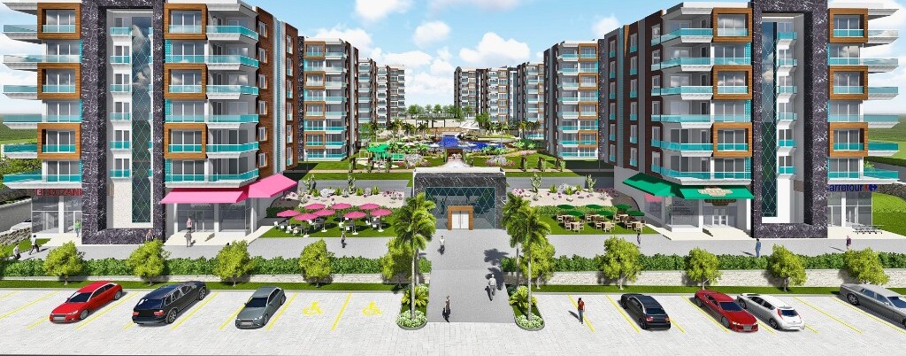 Modern luxury apartment development in Antalya with residential towers, pool courtyard and ground-floor amenities